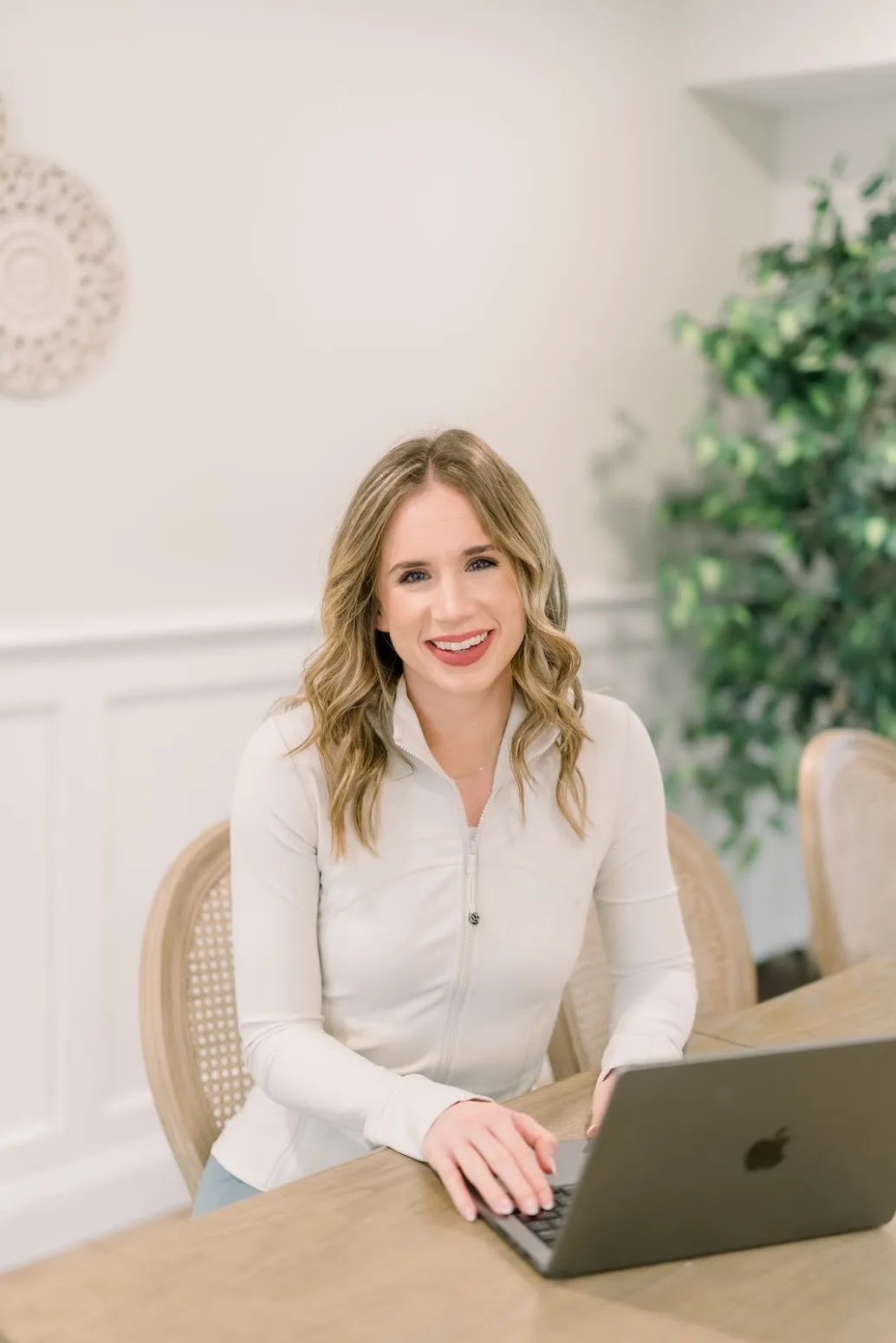 Taylor Wilson working with a client over video from her laptop